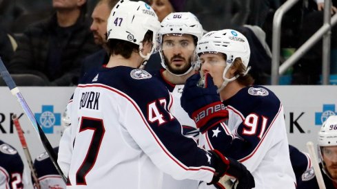 Columbus Blue Jackets defenseman Marcus Bjork and right wing Kirill Marchenko and center Kent Johnson talk before a face-off against the Pittsburgh Penguins during the third period.