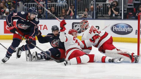 Columbus Blue Jackets' Liam Foudy picks up a rebound of a Carolina Hurricanes' Frederick Andersen save during the second period at Nationwide Arena.