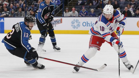 New York Rangers' Artemi Panarin and Columbus Blue Jackets' Johnny Gaudreau chase down a loose puck during the first period at Nationwide Arena.