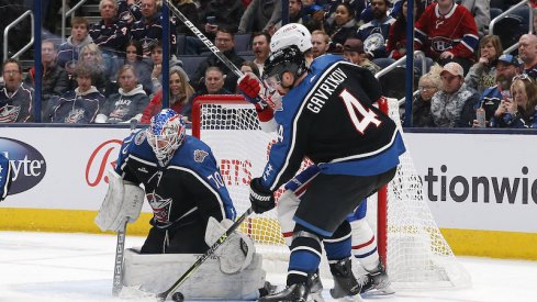 Columbus Blue Jackets' Vladislav Gavrikov clears the puck from a Columbus Blue Jackets' Joonas Korpisalo save against the Montreal Canadiens during the second period at Nationwide Arena.