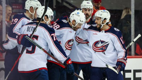 Blue Jackets celebrate after Boone Jenner's game-tying goal against the Flames.