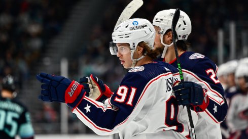 The Columbus Blue Jackets celebrate after Kent Johnson scored a goal against the Seattle Kraken during the second period at Climate Pledge Arena.