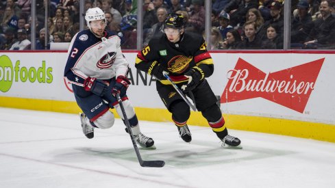 Columbus Blue Jackets' Andrew Peeke and Vancouver Canucks' Ilya Mikheyev battle for the loose puck in the third period at Rogers Arena. Canucks won 5-2.