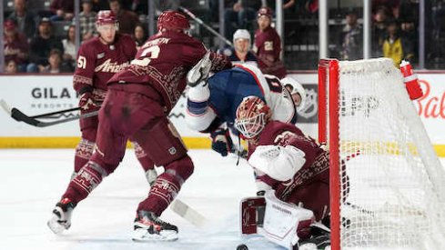 Patrik Nemeth checks Lane Pederson in the Coyotes-Blue Jackets game.