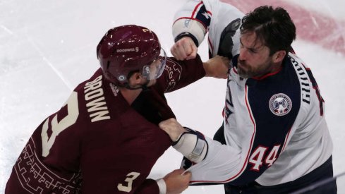 Arizona Coyotes' Josh Brown and Columbus Blue Jackets' Erik Gudbranson fight during the second period at Mullett Arena.