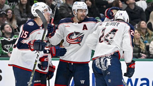 Columbus Blue Jackets' Gavin Bayreuther and Sean Kuraly and Mathieu Olivier skate off the ice after scoring a goal against the Dallas Stars during the third period at the American Airlines Center.