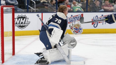 Joonas Korpisalo's mask falls off after making a save in the Wild vs. Blue Jackets game.