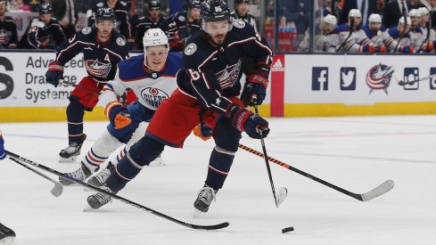 Columbus Blue Jackets' Kirill Marchenko controls the puck as Edmonton Oilers' Jesse Puljujarvi trails the play during the second period at Nationwide Arena.