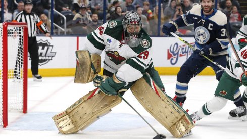 Minnesota Wild's Marc-Andre Fleury clears a loose puck against the Columbus Blue Jackets during the second period at Nationwide Arena.