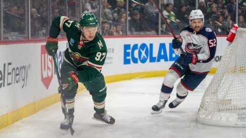 Minnesota Wild's Kirill Kaprizov skates behind the net, followed by Columbus Blue Jackets' Emil Bemstrom at Xcel Energy Center.