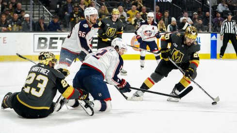 Vegas Golden Knights' Chandler Stephenson skates with the puck against Columbus Blue Jackets' Jack Roslovic and Andrew Peeke during the first period at T-Mobile Arena.