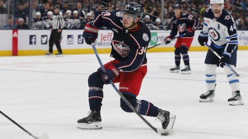 Cole Sillinger shoots the puck in the Jets vs. Blue Jackets game.