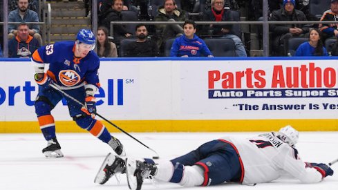 Casey Cizikas moves around Erik Gudbranson in the Islanders vs. Blue Jackets game.