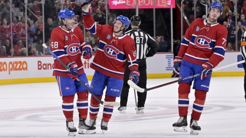 Montreal Canadiens' Rafael Harvey-Pinard celebrates with teammate Mike Hoffman and Kirby Dach after scoring his third goal against the Columbus Blue Jackets during the second period at the Bell Centre.