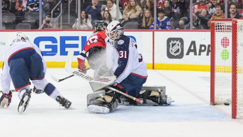 New Jersey Devils center Jack Hughes (86) scores a goal past Columbus Blue Jackets goaltender Michael Hutchinson (31) during the first period at Prudential Center.