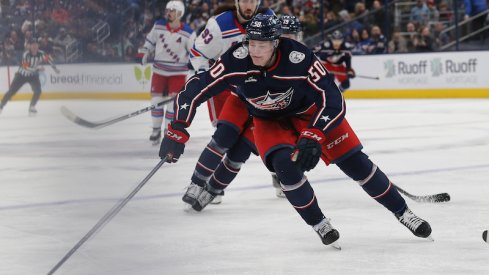 Columbus Blue Jackets' Eric Robinson gains control of a loose puck as New York Rangers Mika Zibanejad trails the play during the second period at Nationwide Arena.