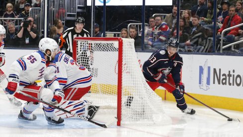 Columbus Blue Jackets left wing Johnny Gaudreau (13) looks to pass from behind the net as New York Rangers defenseman Ryan Lindgren (55) defends during the second period at Nationwide Arena.