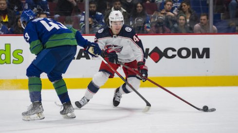Columbus Blue Jackets forward Alexandre Texier (42) drives past Vancouver Canucks defenseman Quinn Hughes (43) in the second period at Rogers Arena.