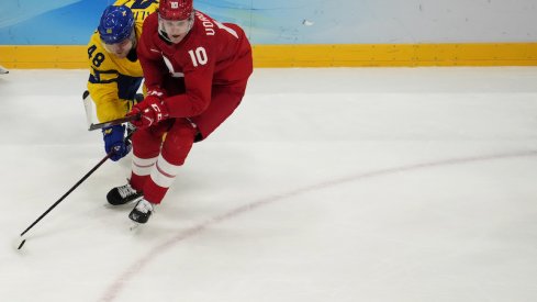 Team ROC forward Dmitri Voronkov and Team Sweden forward Carl Klingberg battle for the puck in the third period during the Beijing 2022 Olympic Winter Games at National Indoor Stadium.