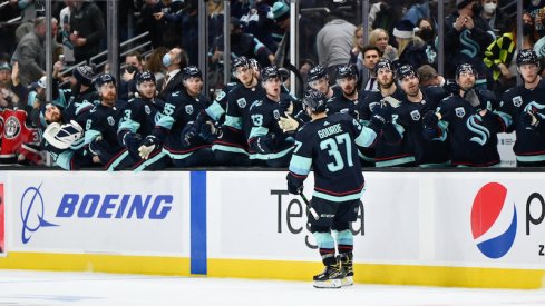 Seattle Kraken's Yanni Gourde celebrates with the bench after scoring a goal against the Calgary Flames during the third period at Climate Pledge Arena.