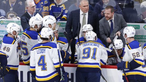 St. Louis Blues Head Coach Craig Berube watches St. Louis Blues Assistant Coach Steve Ott discuss a play during a time out in the third period against the Winnipeg Jets at Canada Life Centre.