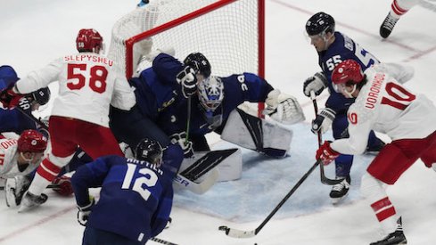 Team ROC forward Dmitri Voronkov (10) attempts to shoot the puck on Team Finland goalkeeper Harri Sateri (29) in the third period during the Beijing 2022 Olympic Winter Games at National Indoor Stadium.