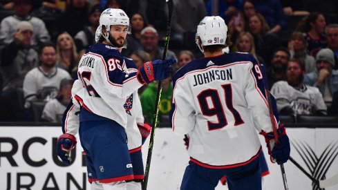 Columbus Blue Jackets right wing Kirill Marchenko (86) celebrates his goal scored against the Los Angeles Kings with center Kent Johnson (91) during the third period at Crypto.com Arena.