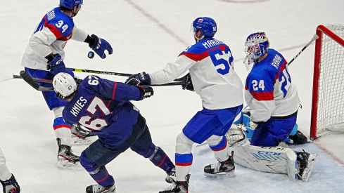 Slovakia's Simon Nemec hits United States' Matt Knies in the face with his stick in the men s ice hockey quarterfinal during the Beijing 2022 Olympic Winter Games at National Indoor Stadium.