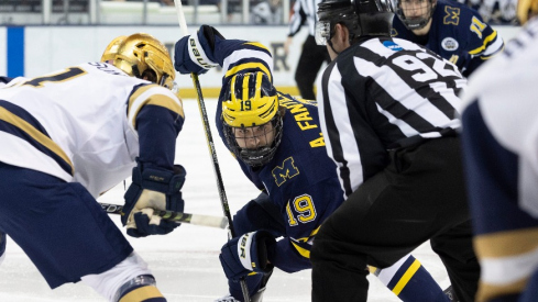 Michigan forward Adam Fantilli (19) and Notre Dame forward Jackson Pierson (11) set to face-off during the Michigan-Notre Dame NCAA hockey game on Saturday, November 12, 2022, at Compton Family Ice Arena in South Bend, Indiana.