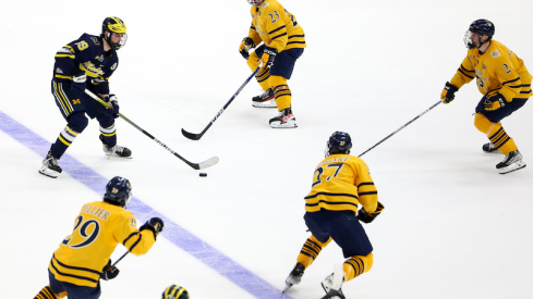 Michigan's Adam Fantilli controls the puck against Quinnipiac during the second period in the semifinals of the 2023 Frozen Four college ice hockey tournament at Amalie Arena.
