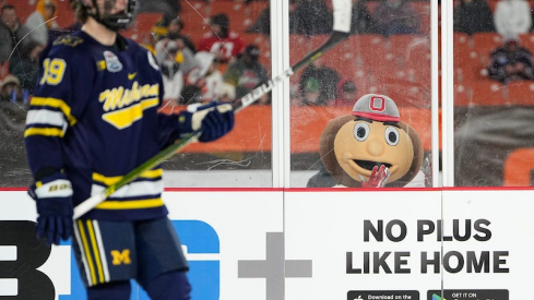Brutus Buckeye watches Michigan Wolverines' Adam Fantilli during third period of the Faceoff on the Lake outdoor NCAA men's hockey game at FirstEnergy Stadium. Ohio State won 4-2.