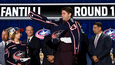 Columbus Blue jackets draft pick Adam Fantilli puts on his sweater after being selected with the third overall pick 