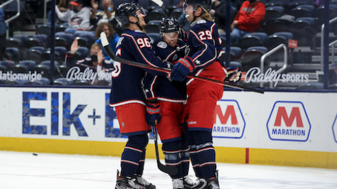 Columbus Blue Jackets right wing Cam Atkinson (middle) celebrates with teammates center Jack Roslovic (left) and right wing Patrik Laine (right) after scoring a goal against the Detroit Red Wings in the 1st period at Nationwide Arena.
