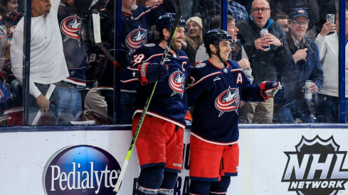 Columbus Blue Jackets center Boone Jenner (38) celebrates with teammate left wing Johnny Gaudreau after scoring the game-winning goal against the New York Islanders in the overtime period at Nationwide Arena.