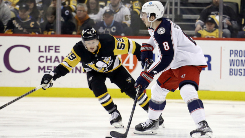 Columbus Blue Jackets' Zach Werenski moves the puck against Pittsburgh Penguins' Jake Guentzel during the third period at PPG Paints Arena