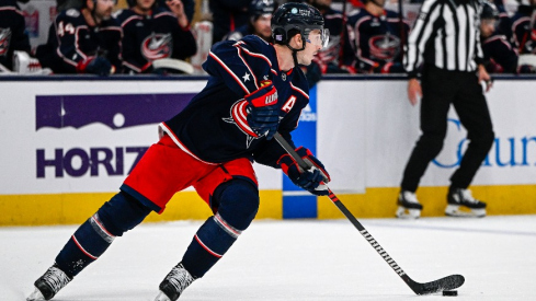 Columbus Blue Jackets defenseman Zach Werenski (8) skates with the puck against the Philadelphia Flyers in the first period at Nationwide Arena.