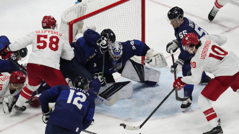 Team ROC's Dmitri Voronkov attempts to shoot the puck on Team Finland's Harri Sateri in the third period during the Beijing 2022 Olympic Winter Games at National Indoor Stadium.