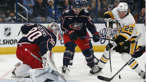 Pittsburgh Penguins' Sam Poulin reaches for the rebound of Columbus Blue Jackets' Elvis Merzlikins save during the first period at Nationwide Arena.