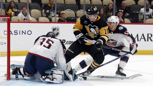 Columbus Blue Jackets defenseman David Jiricek defends Pittsburgh Penguins left wing Drew O'Connor