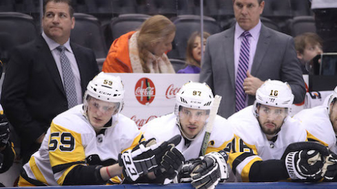 Pittsburgh Penguins center Jake Guentzel (59) and center Sidney Crosby (87) and right wing Josh Jooris (16) look on from the bench as assistant coach Mark Recchi and head coach Mike Sullivan look on against the Toronto Maple Leafs at Air Canada Centre. The Maple Leafs beat the Penguins 5-2.