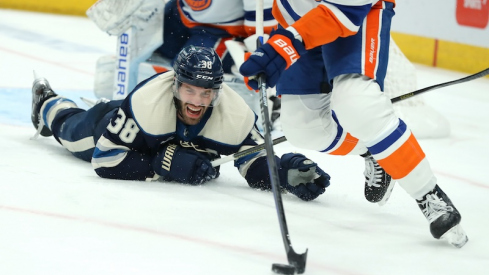 Columbus Blue Jackets' Boone Jenner looks at the loose puck as New York Islanders defenseman Adam Pelech (3) skates up the ice during the second period at Nationwide Arena.