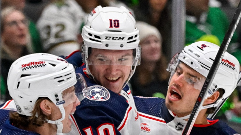 Columbus Blue Jackets center Kent Johnson (91) and left wing Dmitri Voronkov (10) and center Cole Sillinger (4) celebrates a goal Voronkov against the Dallas Stars during the first period at the American Airlines Center.