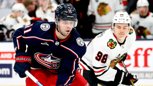 Columbus Blue Jackets center Adam Fantilli (11) shoots the puck as Chicago Blackhawks center Connor Bedard (98) trails the play during the first period at Nationwide Arena.