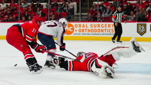 Carolina Hurricanes goaltender Pyotr Kochetkov (52) and right wing Andrei Svechnikov (37) stop the scoring attempt by Columbus Blue Jackets right wing Justin Danforth (17) during the second period at PNC Arena.