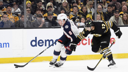 Zach Werenski skates past Boston Bruins defenseman Kevin Shattenkirk