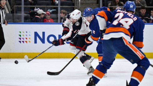 Columbus Blue Jackets' Adam Fantilli shoots the puck as New York Islanders' Mike Reilly defends during the first period at UBS Arena.