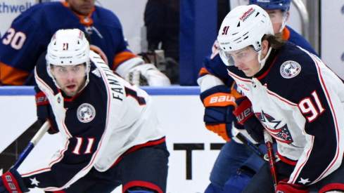 Columbus Blue Jackets center Kent Johnson (91) controls the puck as New York Islanders defenseman Noah Dobson (8) defends during the first period at UBS Arena.