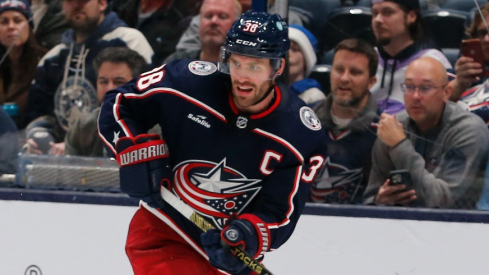 Columbus Blue Jackets center Boone Jenner (38) passes the puck over the stick of Los Angeles Kings center Phillip Danault (24) during the third period at Nationwide Arena.