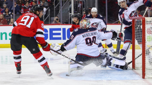 Columbus Blue Jackets goaltender Elvis Merzlikins (90) makes a save on New Jersey Devils center Dawson Mercer (91) during the second period at Prudential Center.