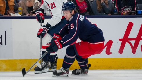 Washington Capitals center Aliaksei Protas (21) passes the puck against Columbus Blue Jackets defenseman Denton Mateychuk (5) in the first period at Nationwide Arena.